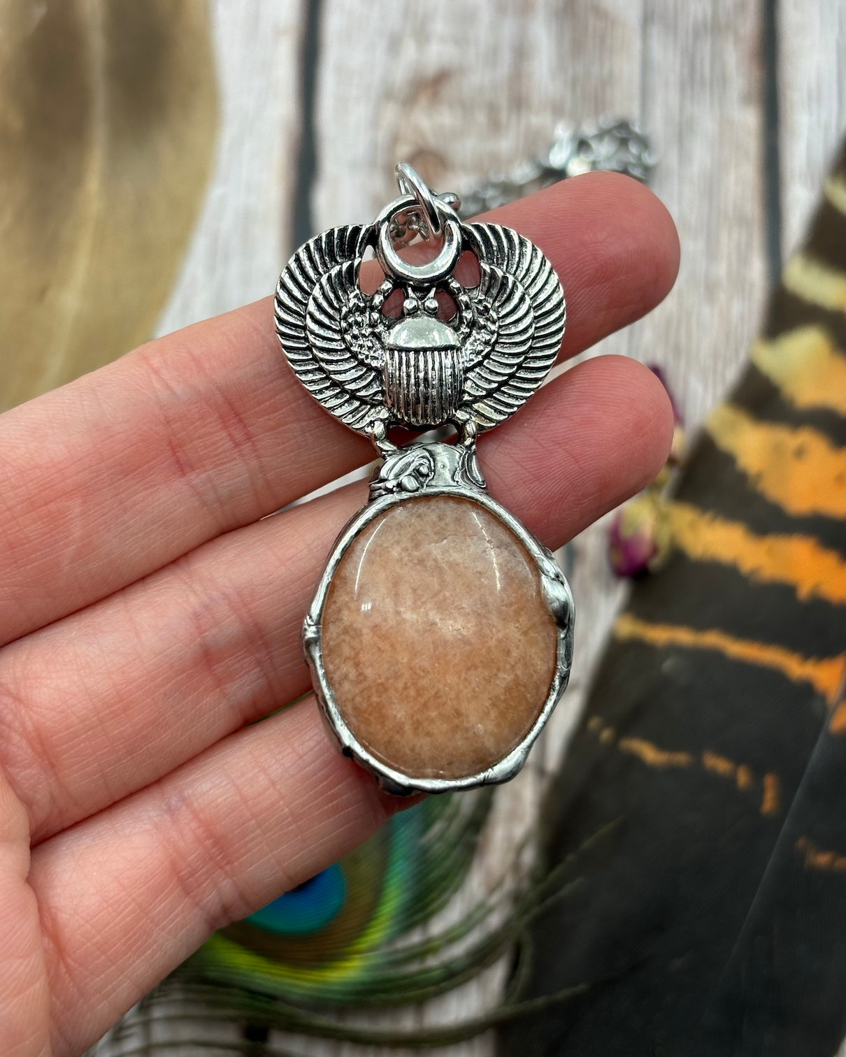 silver Egyptian scarab beetle pendant with a sunstone attached below it