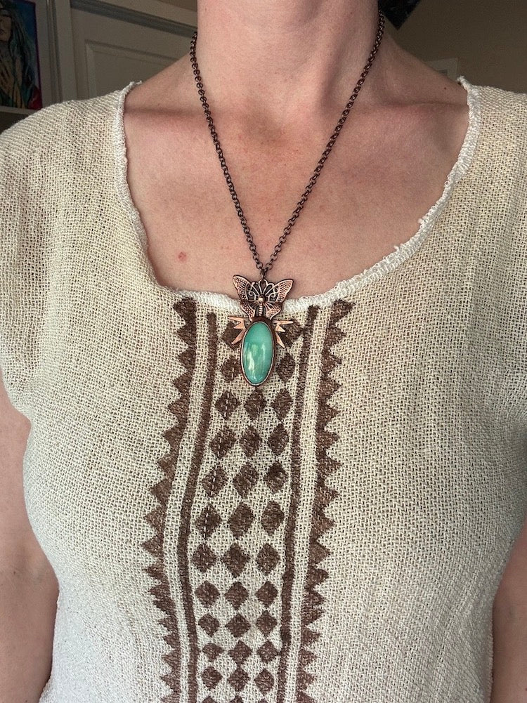 Model wearing Butterfly necklace with chrysoprase, copper electroformed jewellery