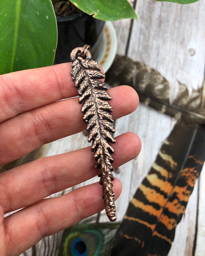 tattered leaf copper electroformed pendant with a real fern inside